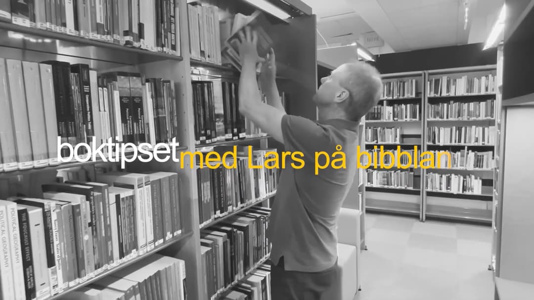 man i bibliotek som tar ned böcker från hyllan