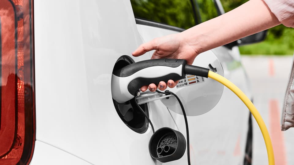 38861976-woman-unplugging-a-charger-from-an-electric-car-socket.jpg