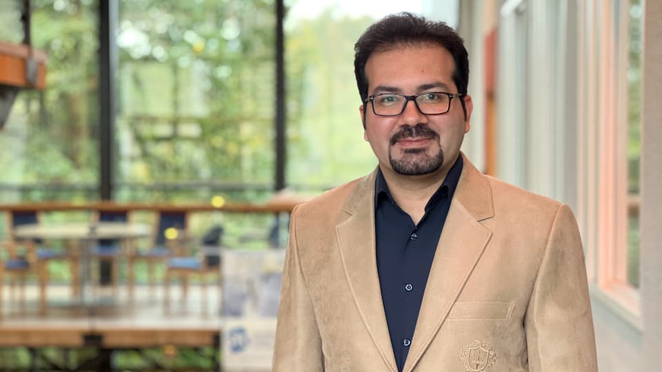 Man with glasses and a bright jacket