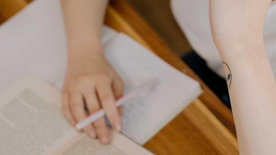 A woman studying by a desk