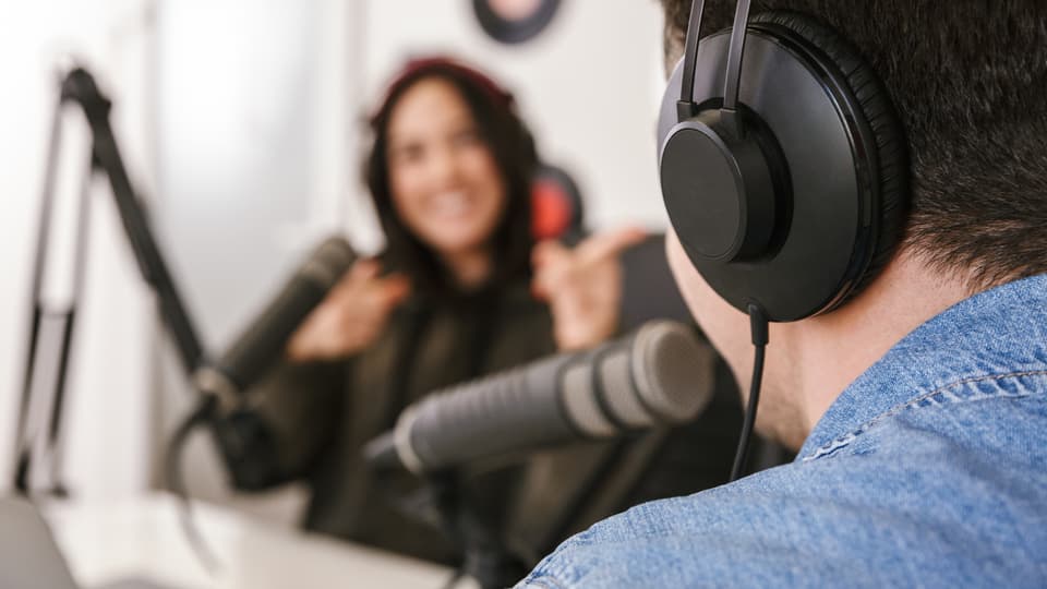 32516445-man-and-woman-in-white-shirts-podcasters-interview.jpg