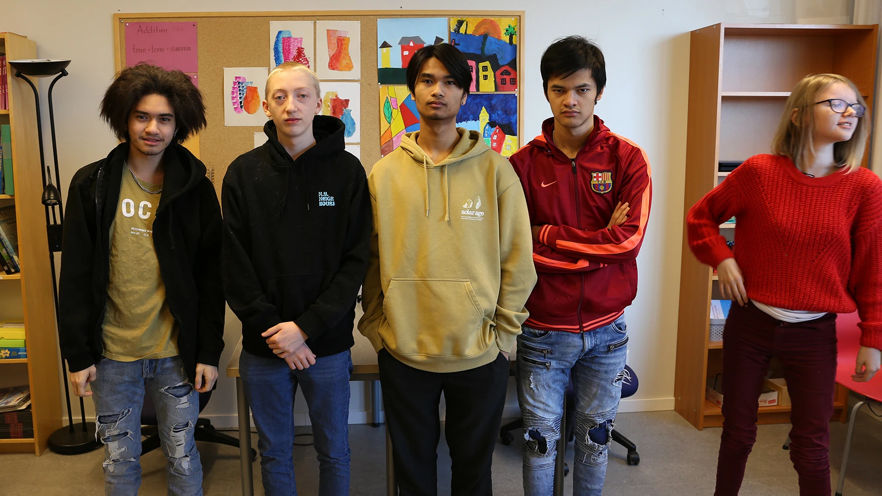 Five students who have set up for a group picture.