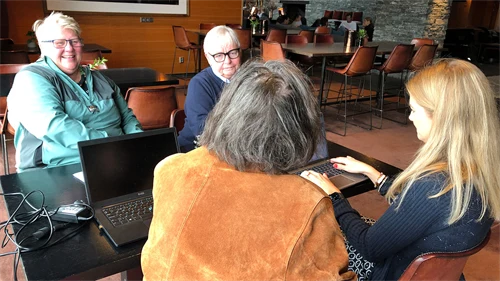 Four women in a discussion around a table.
